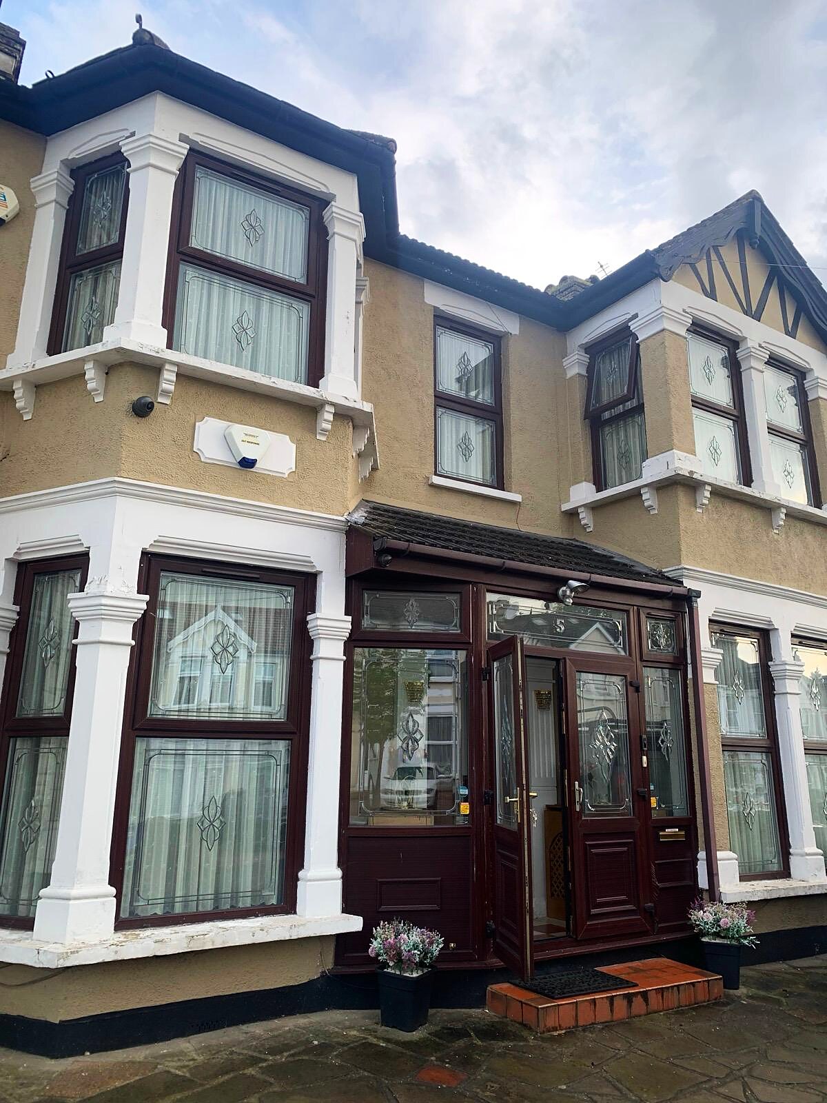 Mahogany-effect UPVC windows and porch fitted by Deluxe Glazing